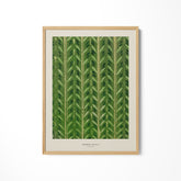 a green leaf print hanging on a wall