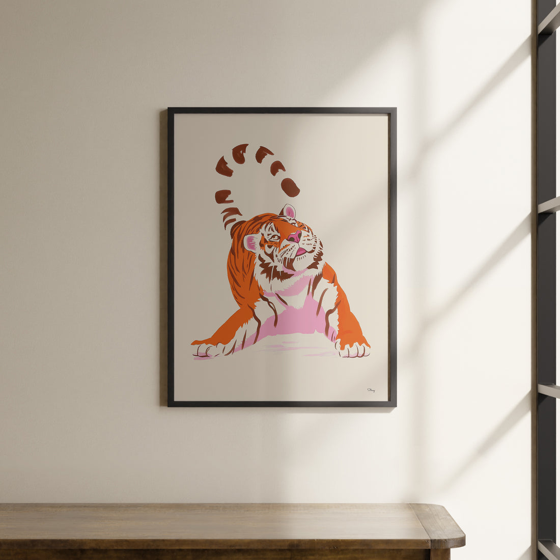 a framed picture of a tiger on a wall