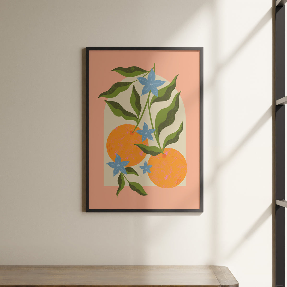 a painting of oranges and blue flowers hangs on a wall