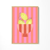 a picture of a bowl of lemons on a pink and pink striped background