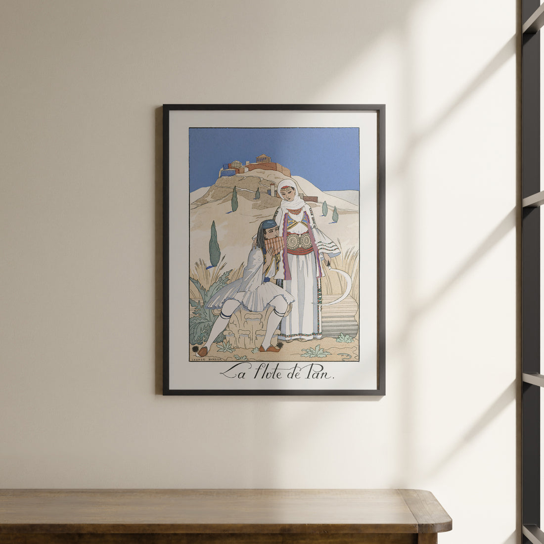 a picture hanging on a wall above a wooden table